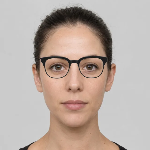 Oval face wearing browline glasses